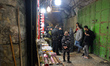 Israeli security forces officers checking IDs inside the Old City of Jerusalem following a...