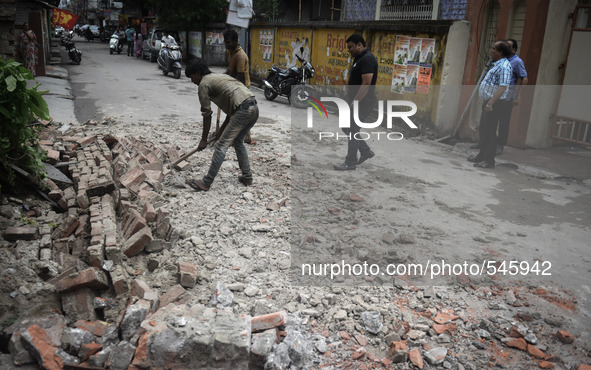 Indian people walk following an earthquake, in Siliguri on April 25, 2015. A powerful 7.9 magnitude earthquake struck Nepal, causing massive...