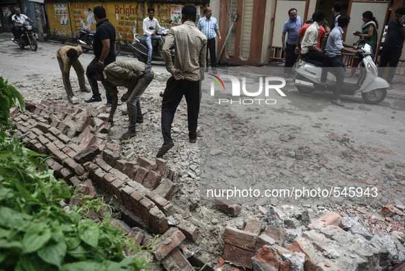Indian people walk following an earthquake, in Siliguri on April 25, 2015. A powerful 7.9 magnitude earthquake struck Nepal, causing massive...