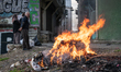 On 22 Feb. 2020, a family burns trash and plastic waste in a low-income neighborhood near...