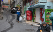 On 22 Feb. 2020, an elderly man sifts through trash on the street in a low-income neighbor...