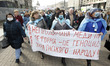 Ukrainian medical workers wearing face masks participate at a rally against health reform,...