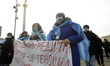 Ukrainian medical workers wearing face masks participate at a rally against health reform,...