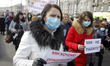 Ukrainian medical workers wearing face masks participate at a rally against health reform,...