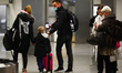 Passengers wearing protective masks arrived in a flight from Milano, Italy to Krakow Airpo...
