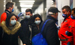 Health personnel monitors body temperature of passengers who arrived in a flight from Mila...