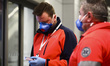 Health personnel monitors body temperature of passengers who arrived in a flight from Mila...