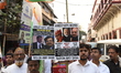 A group of protesters holds placards during the protest rally against recent brutal and vi...
