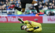  Dwight Gayle (12) of Newcastle United (legs in shot) hurdles over Nick Pope (1) of Burnle...