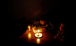 A Palestinian boy studies by candlelight at their family's house during a power cuts in Ra...