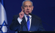 Israeli Prime Minister Benjamin Netanyahu speaks to supporters following the announcement...