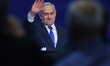 Israeli Prime Minister Benjamin Netanyahu gestures as he speaks to supporters following th...