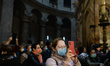 Pilgrims wearing protective masks seen inside the Church of the Holy Sepulchre in Jerusale...