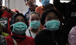 Officers check the temperatures of the visitors of the Cipinang Narcotics prison in Jakart...