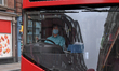 A bus driver is seen at work as he wears a protection mask, London on March 19, 2020. Tran...