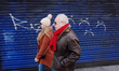 People walk past a shuttered sushi restaurant on a near-deserted Tottenham Court Road in L...