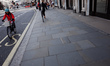 A cyclist rides along a near-deserted Regent Street in London, England, on March 21, 2020....