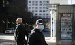 Passerby are seen near a cross walk, in New York, United States, on March 24, 2020.  	In t...