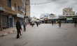 Tunisians walk in the street next to the municipal market of Ariana downtown, northern Tun...