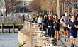  A view of a Hudson River Park with a huge crowd of people exercising despite orders by th...