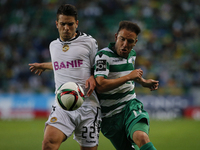 Nacional's defender Nuno Campos (L) vies for the ball with Sporting's midfielder Diego Capel (R)  during the Portuguese League  football mat...