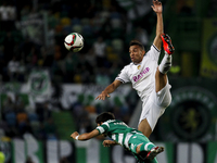 Nacional's defender Marcal (R) vies with Sporting's midfielder Andre Martins during the Portuguese League football match between Sporting CP...