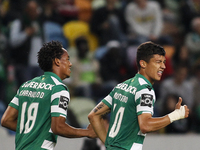 Sporting's Colombian forward Fredy Montero (R) celebrates with Sporting's Peruvian forward Andre Carrillo after scoring a goal during the Po...