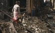 Survivors of the 2015 Nepal earthquake begin to search through the rubble of damaged build...
