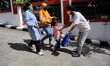  A prisoner with a yellow mask hugs his family after getting parole in class I Detention H...