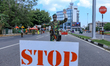Sri Lankan Special Task Force soldier wearing a protective face mask stops vehicles for in...