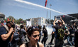 ISTANBUL, TURKEY--Journalists film the police firing water cannons at protesters in Taksim...