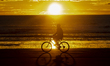 A man rides a bicycle along the empty New Brighton beach in Christchurch, New Zealand, on...