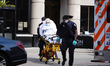 A view of a patient being wheeled out of a nursing home in Flushing Queens New York USA du...