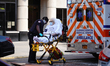 A view of a patient being wheeled out of a nursing home in Flushing Queens New York USA du...