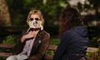 A view of a person wearing a mask in Madison Square Park, New York City USA during coronav...