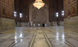 Muslims offer prayers while practicing social distancing inside closed Grand Mosque of Del...