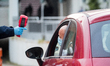A security agent  scans the body temperature of an employee of Italian automobile manufact...