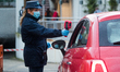 A security agent  scans the body temperature of an employee of Italian automobile manufact...