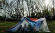 A family is sitting inside of their tent at the Golf field temporary shelter, Kathmandu, 2...