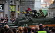 Local recisdents watch the military parade rehearsal as they passes thought Tverskaya Stre...