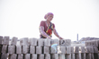 a women worker wokring at a brick-field factory  on May 5, 2015 in Dhaka, Bangladesh.
