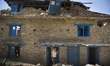 SINDHUPALCHOK, NEPAL-- May 5, 2015--A man inside the doorframe of his heavily damaged hous...