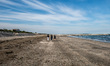Three young girls walking at the beach in Lido di Venezia. The permission to go to the bea...