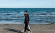A couple walking at the beach of Lido di Venezia on the 8th of May 2020. The permission to...