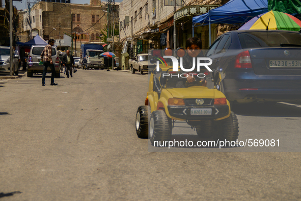 A child is playing with his car in Hebron, Palestine, May 6th 2015.  