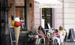 People are seen at an ice cream parlour in the Old Town in Warsaw, Poland on May 11, 2020....