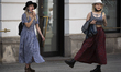 Two young women with ice creams are seen dancing in Warsaw, Poland on May 11, 2020. In a p...