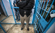A security guard stands firm in front a door of a prison cell in the Katiba prison in Gaza...