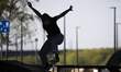 A young woman is seen skateboarding on the boulevard along the Vistula river in Warsaw, Po...