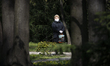 A woman wearing a face cover is seen in the Royal Baths park just several days after the g...
